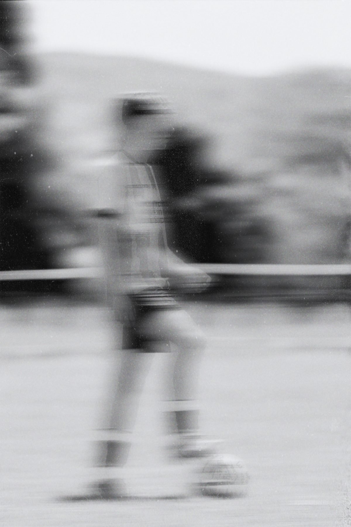 Blurred figure of a player driving forward with the ball