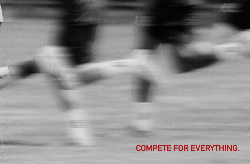 Long exposure of players sprinting, legs blurred into streaks